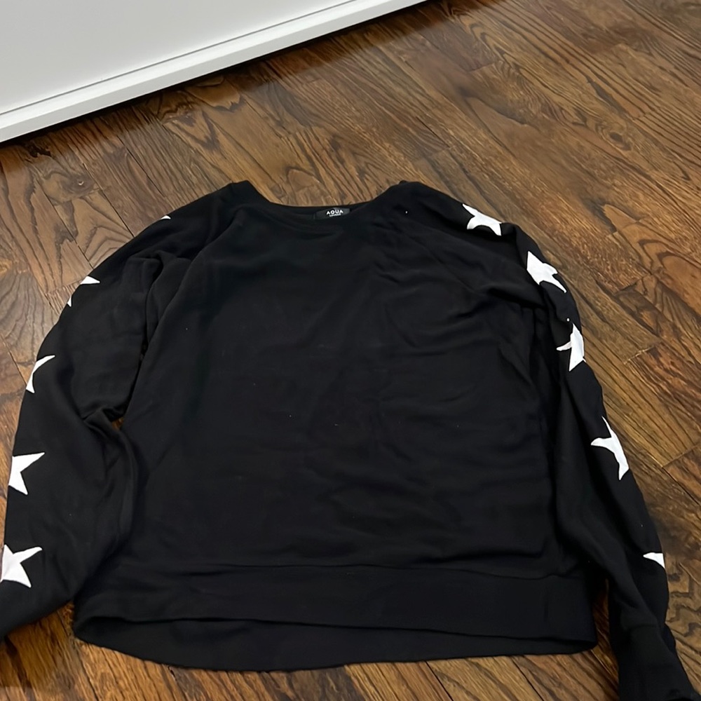black long sleeve sweater material with white stars along arms